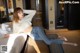 A woman laying on a bed in a hotel room.