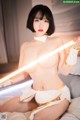 A woman in a white outfit holding a light saber.