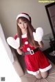 A woman in a santa claus outfit posing for a picture.