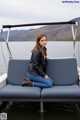 A woman sitting on a boat in the water.