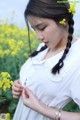 A woman in a field of yellow flowers.