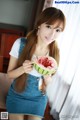 A woman holding a slice of watermelon in her hand.