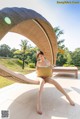 A woman sitting in a hammock on a patio.