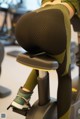 A woman is sitting on a stationary bike in a gym.