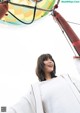 A woman standing in front of a hot air balloon.